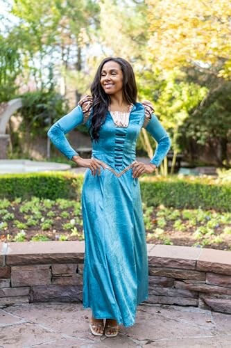 Woman in a blue medieval-style dress standing outdoors.